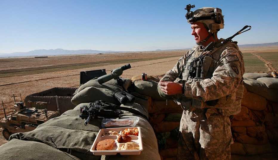a soldier is eating a meal while on duty