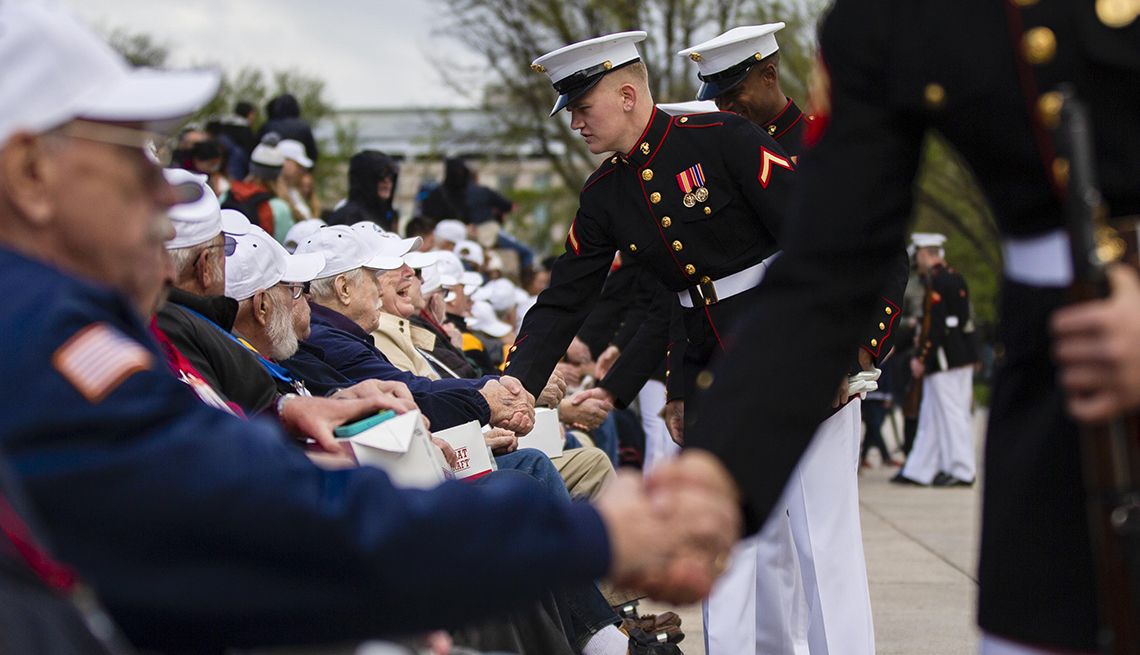 marines shake the hands of veterans