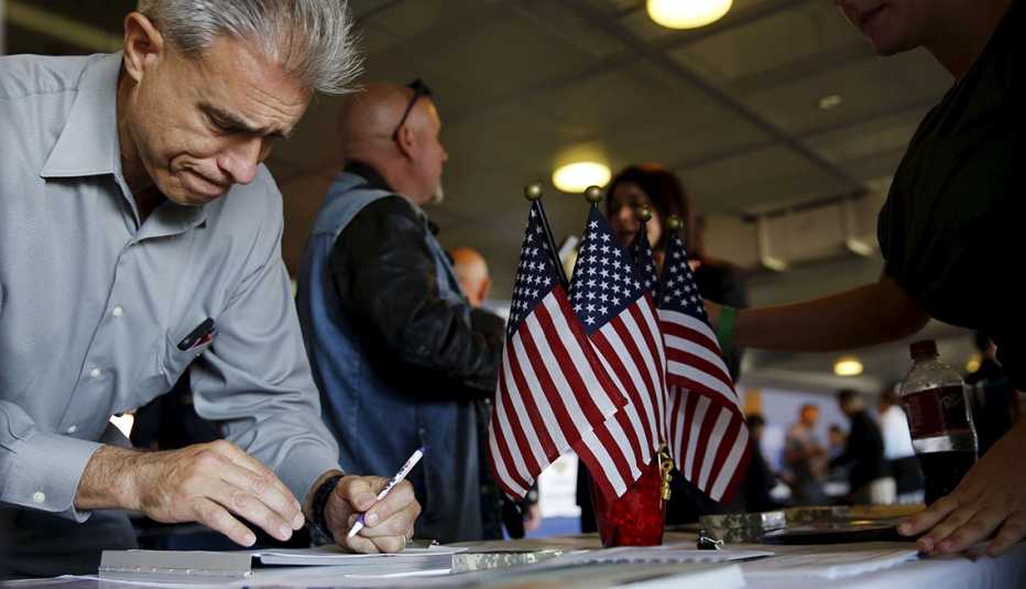 a person is filling out paperwork at a table with american flags