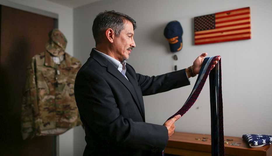 veteran christian cashmir looks at different ties to choose one to wear