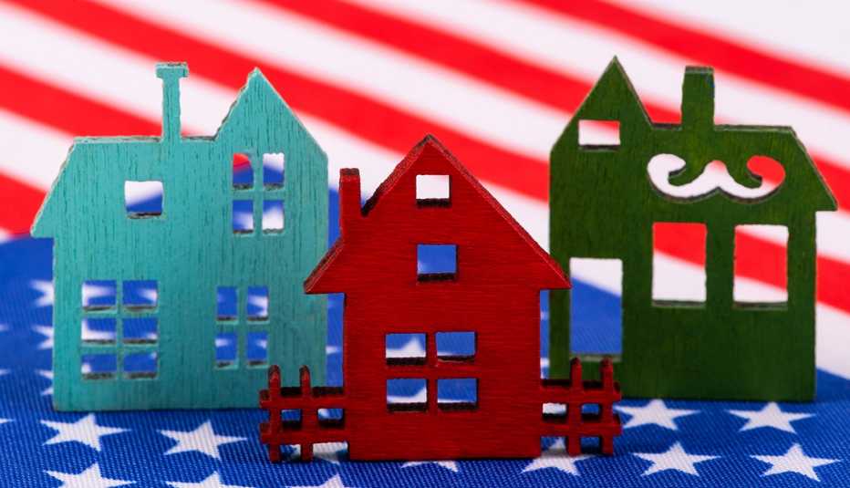 Multicolored wooden house toys set against an American flag background