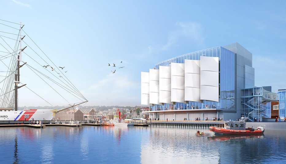 a photo rendering shows a waterfront museum with white flags and multiple coast guard boats in the water