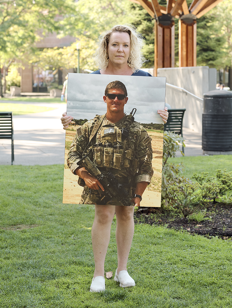 Michelle Black holds an image of her husband, Bryan C. Black.