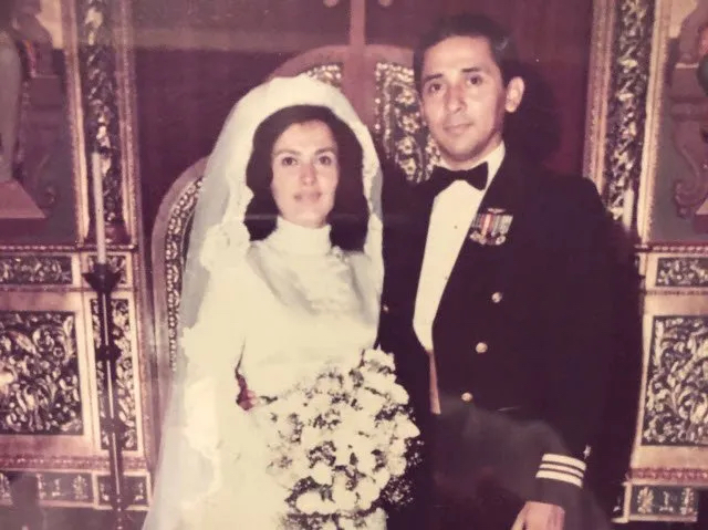 an old photo shows tammy and everett alvarez on their wedding day. she is in a white dress and long veil and he is in a navy dress uniform