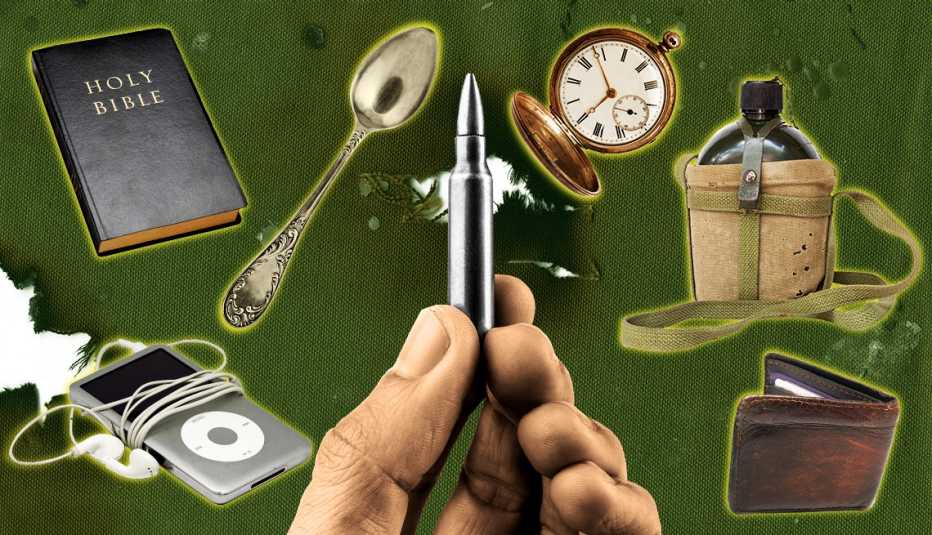 a hand is holding a bullet with items behind it