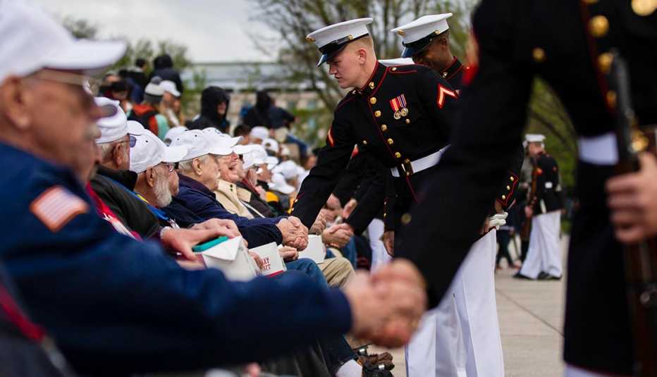 marines shake the hands of veterans