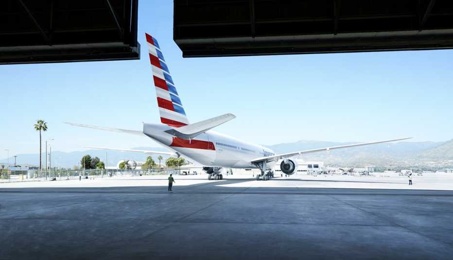 an american airlines plane leaves an airport hanger