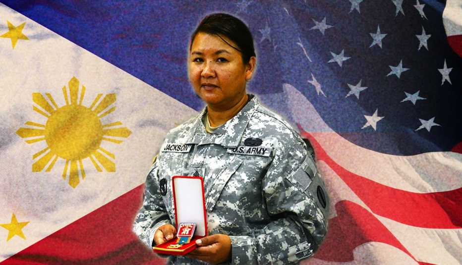 a woman soldier stands before two flags while holding a medal