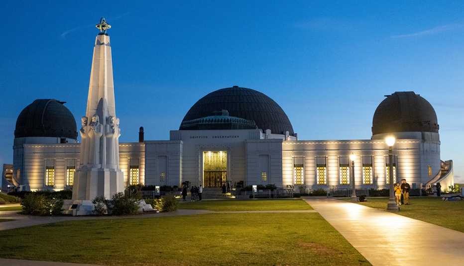 visitors arrive at griffith observatory in los angeles in the evening