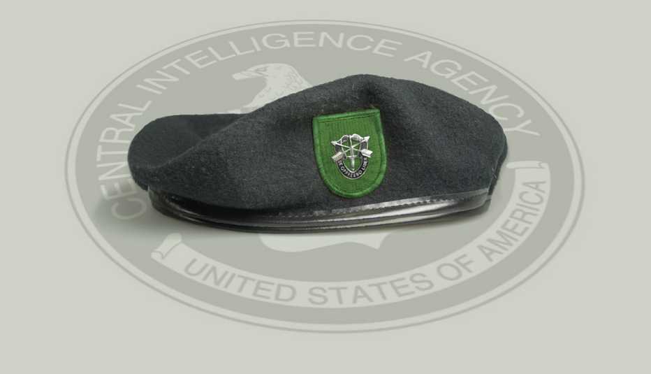 a green beret sits on top of a central intelligence agency logo