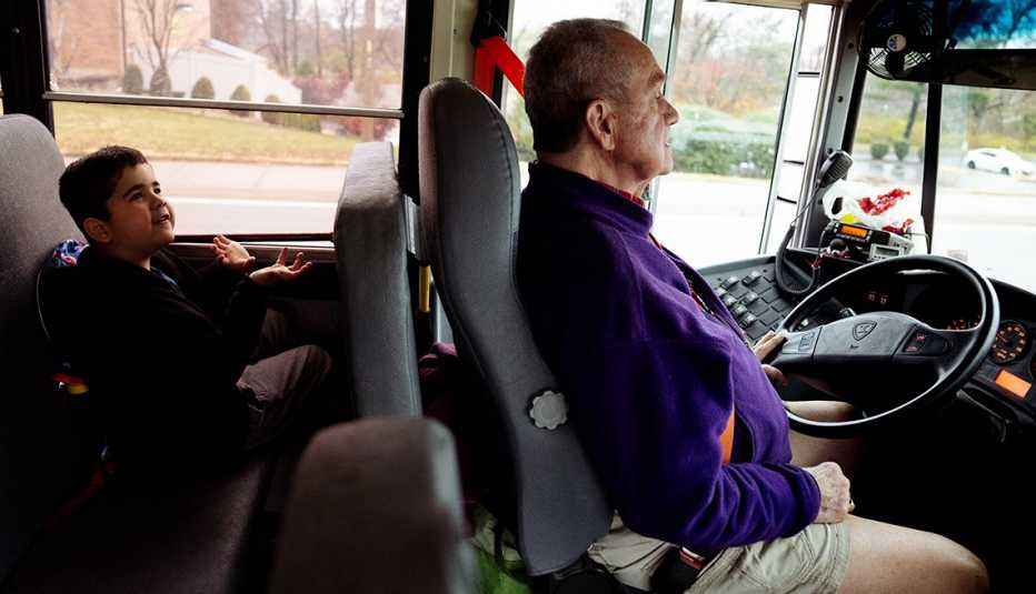 6-year-old student caden cochren talks to his 80-year-old bus driver, Marine Corps veteran bill goodbread