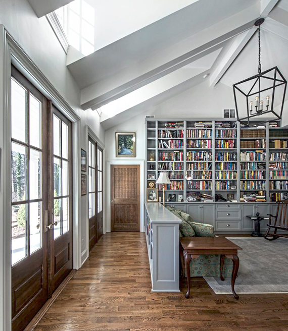 an interior of a home with high ceilings and skylights and a built in library