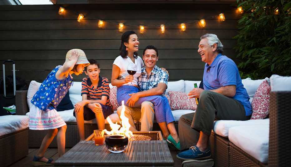 Family relaxing around fire pit outdoors