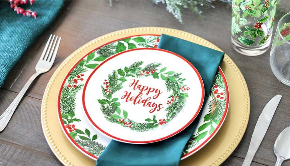 festive happy holidays plates napkins cups and silverware