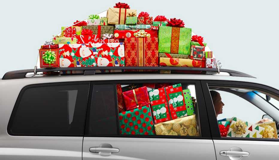 A woman driving an SUV filled with Christmas presents.
