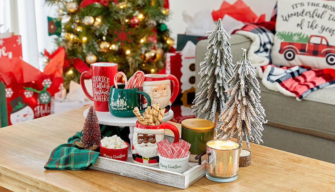 holiday decorations such as festive mugs candles pillows and mini trees