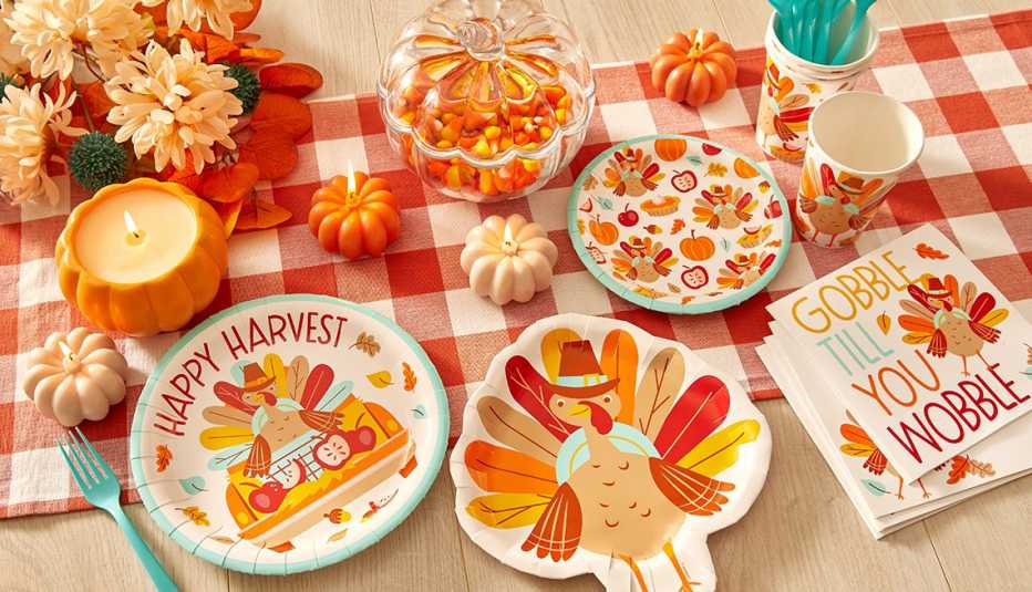 an array of thanksgiving decorations from dollar general including thanksgiving paper plates  candles napkins and containers