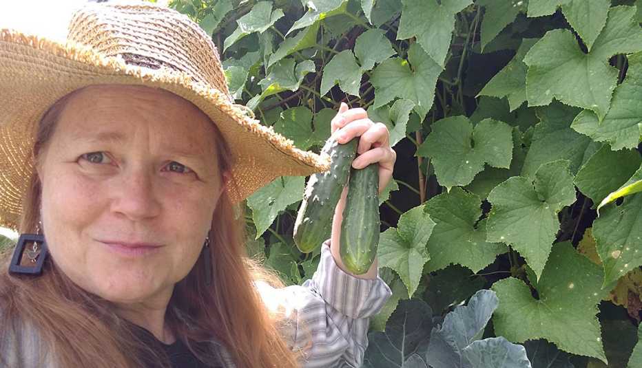 Teresa Konechne in her garden with cucumbers