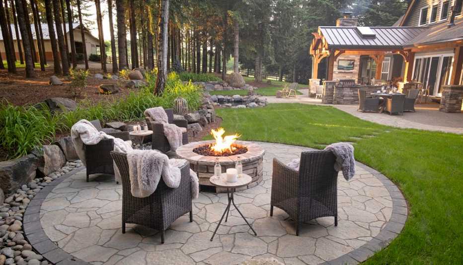A firepit and seating with cozy comforters
