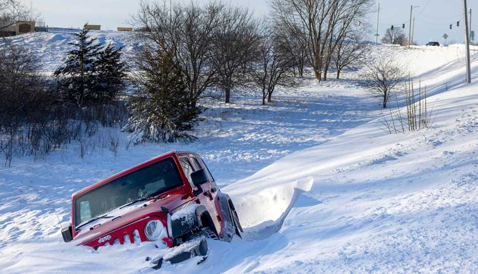 a red Jeep stuck in the snow