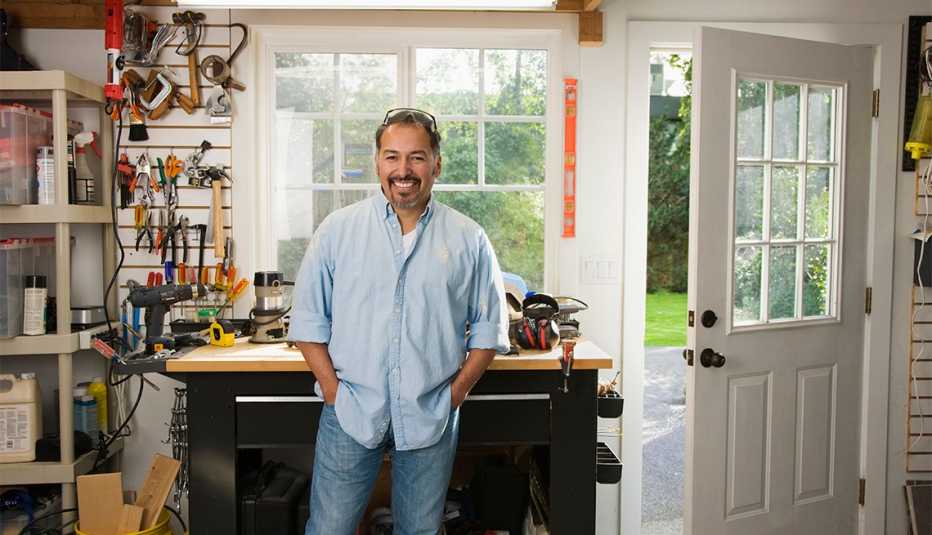man smiling in a garage workshop