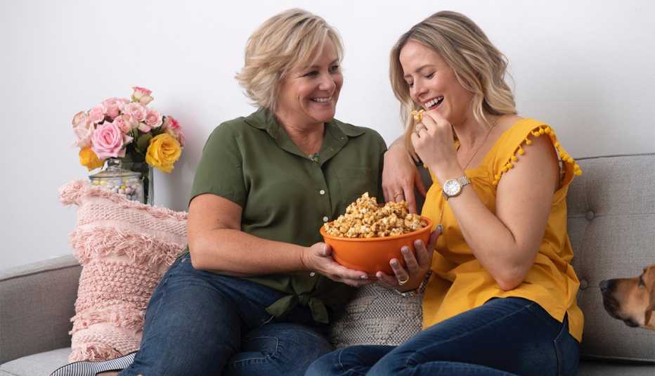 two females eating caramel popcorn