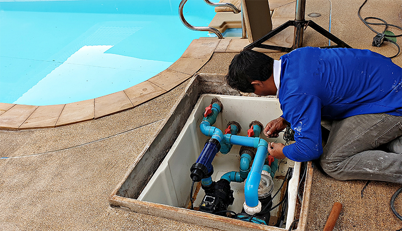 Technician fixing swimming pool water pump
