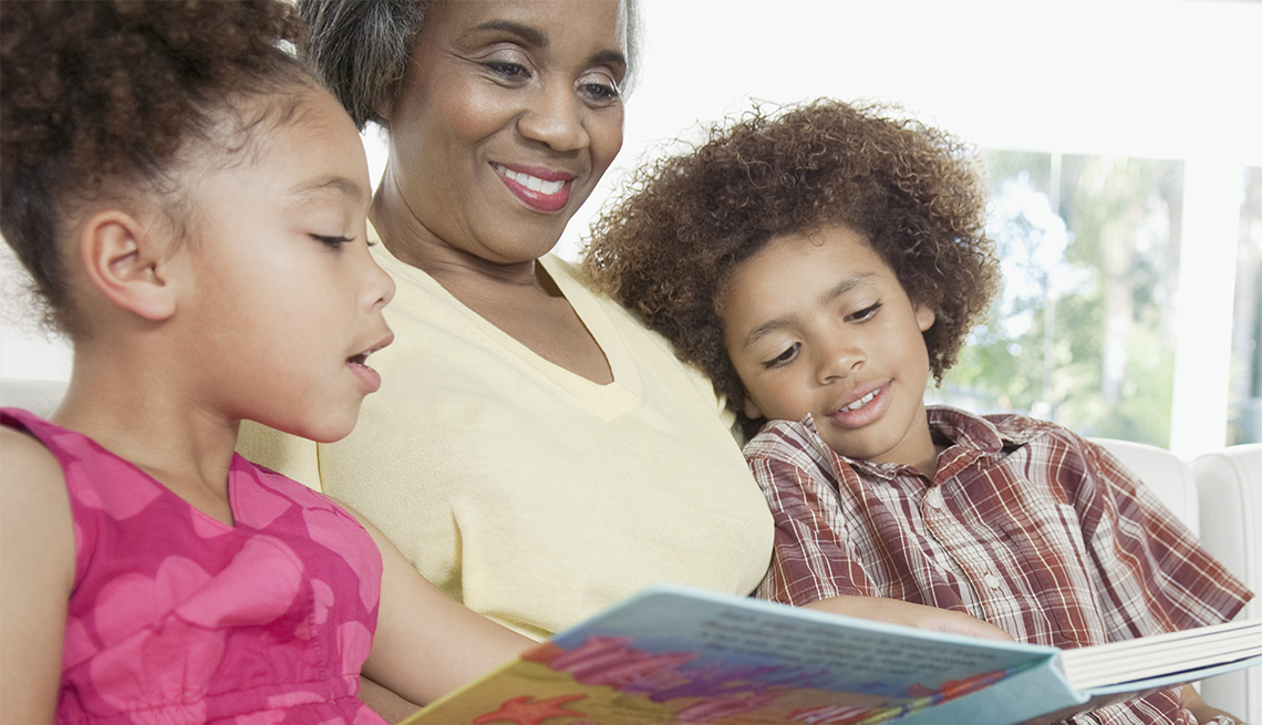 A grandmother is reading to her grandchildren