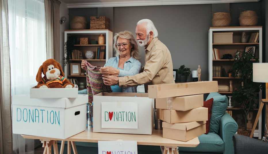 a man and a woman sort through items to donate