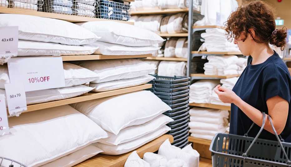 woman enjoying her shopping for pillows at department store