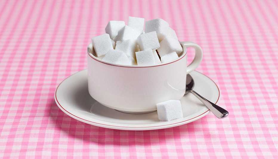 sugar cubes in a teacup on a table