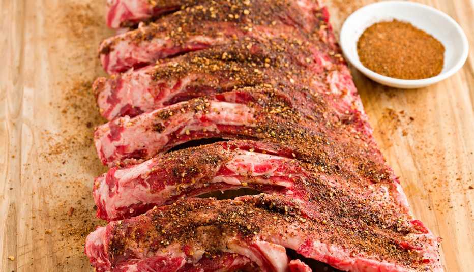 a slab of beef ribs with a bowl of spicy, Texas style dry rub 