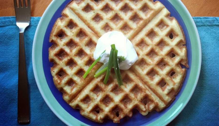large matzo ball soup flavored waffle topped with sour cream and chives
