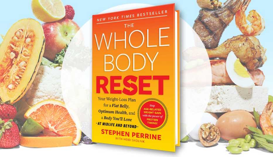 the whole body reset book  in front of piles of healthy food