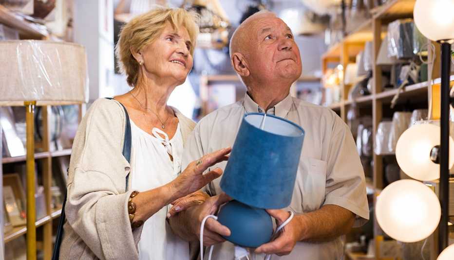a couple in a store shopping for lamps