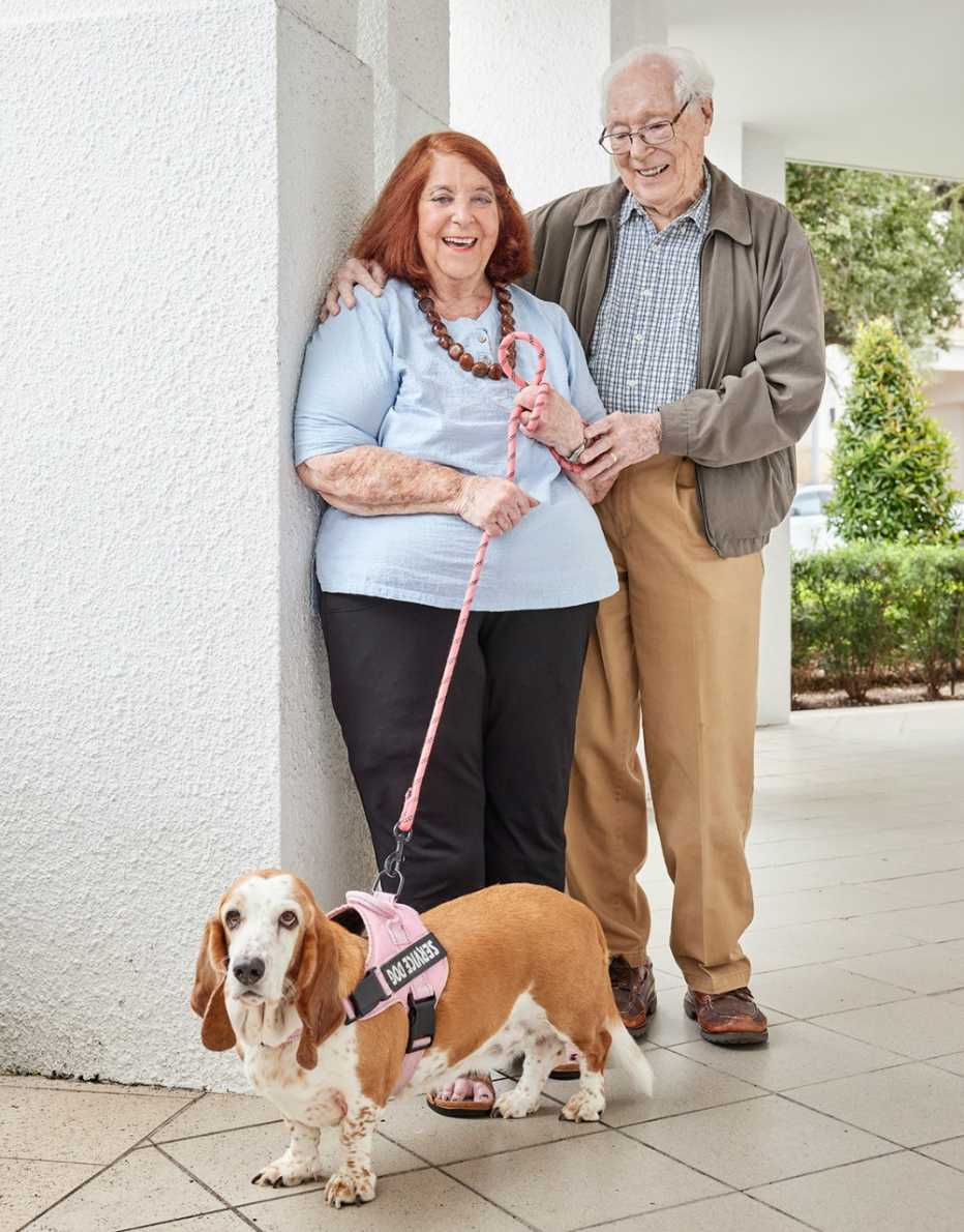 sally and bert russell posing with their dog