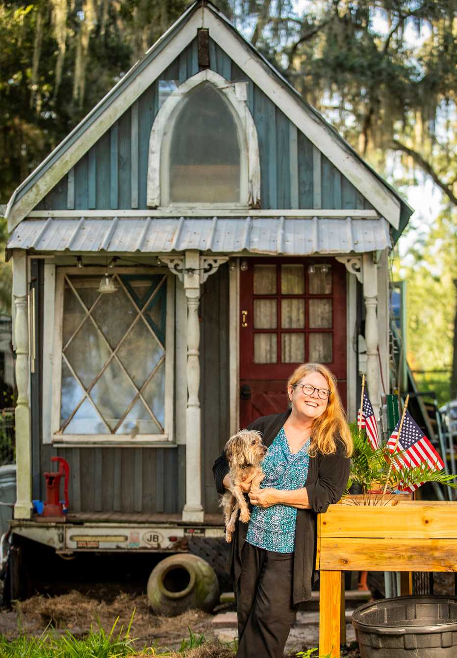 shorty robbins stands outside her tiny home with her dog