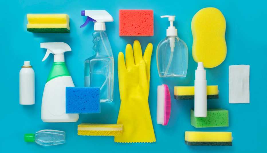 assorted cleaning supplies such as sponges gloves and spray bottles