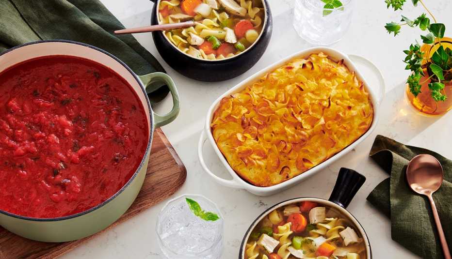 multiple colorful fall dishes on a white table