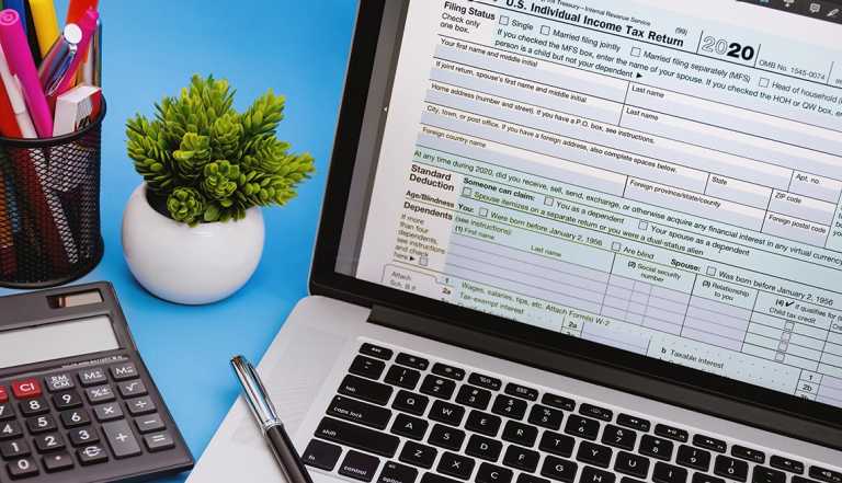 tax form 1040 on laptop screen on light blue background