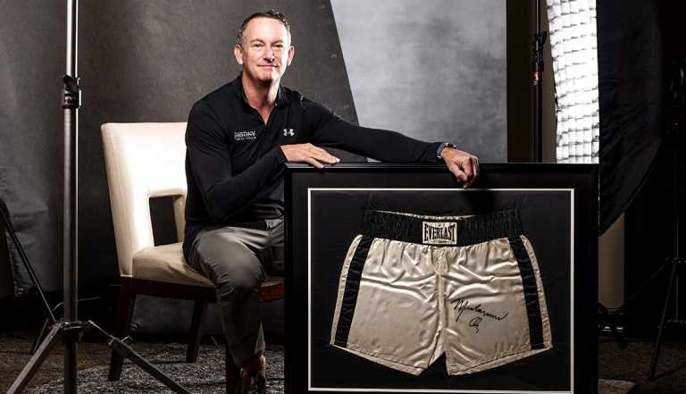 thomas ruggie with framed boxing trunks that were﻿ worn by muhammad ali