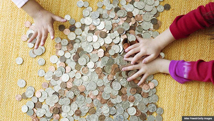 Children counting money on the floor