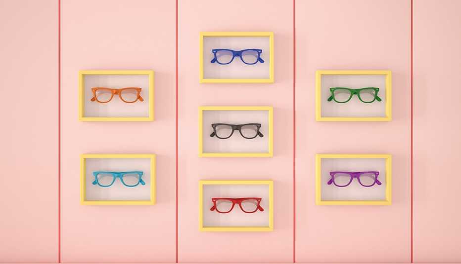 Eye glasses in picture frames against a wall