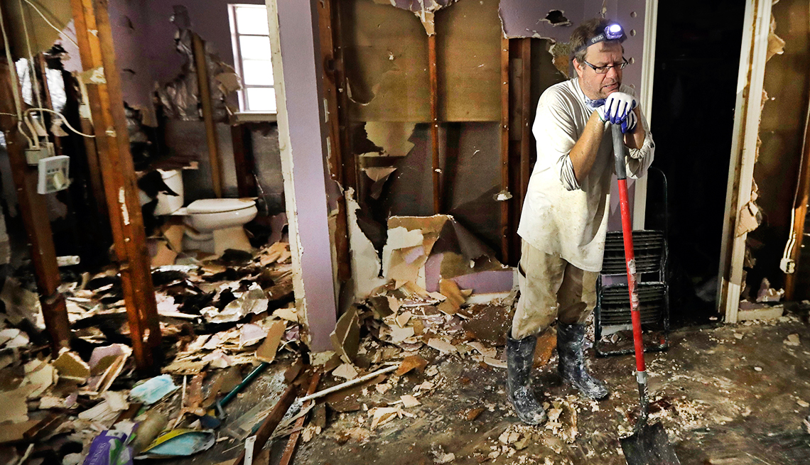 Edward Woods takes a break from cleaning up his mother's home, which was destroyed by floodwaters in the aftermath of Hurricane Harvey in Spring, Texas. 