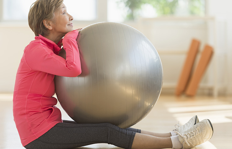 Woman exercising with fitness ball. 99 Ways to Save.