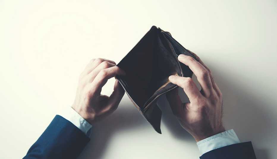 man showing empty wallet