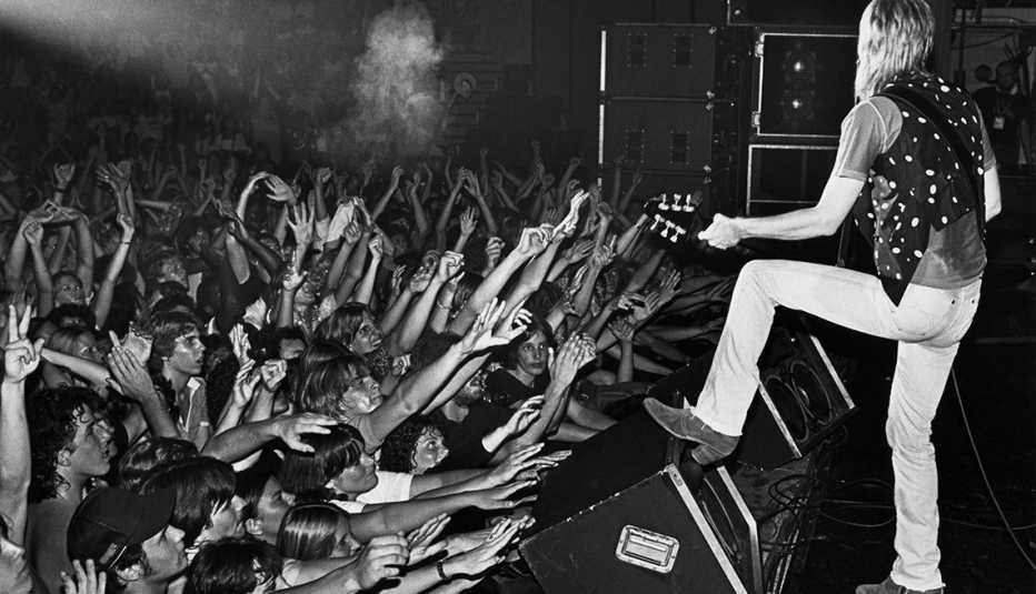 Singer Tom Petty performs onstage to an enthusiastic crowd in a 1980 concert at the Civic Auditorium in Santa Cruz, California.
