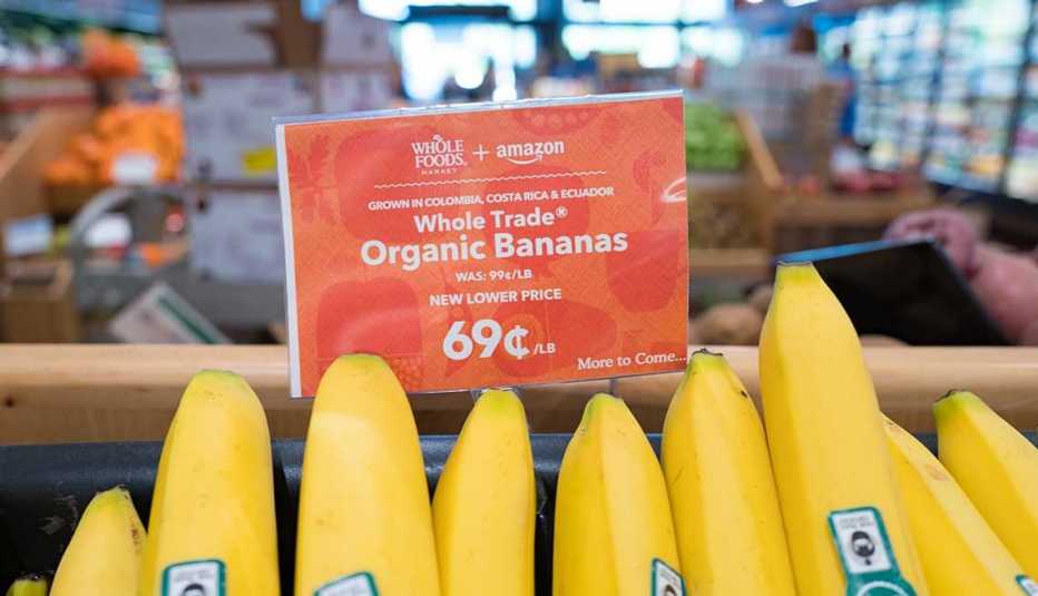 Signage on a display of bananas at the Whole Foods Market store in San Ramon, California reading "Whole Foods Market and Amazon, New Lower Price, More to Come", announcing Whole Foods Market's lowering of prices on many fresh items following its acquisiti
