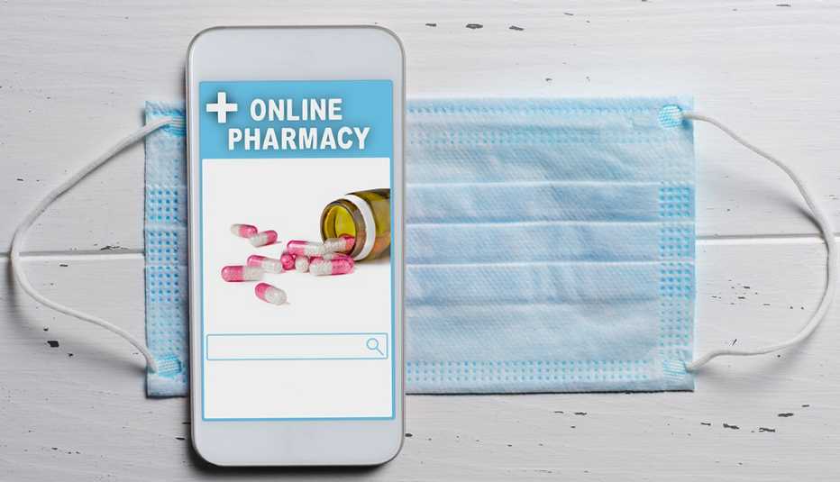 smartphone app screen displays online ordering of medicines; the phone is shown on top of a disposable face mask 