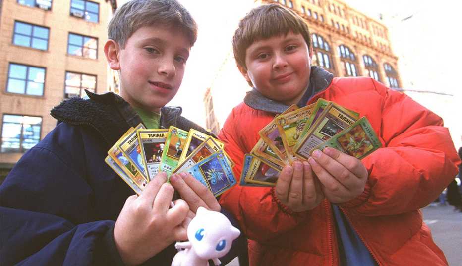 two children standing in street display collectible pokemon trading cards